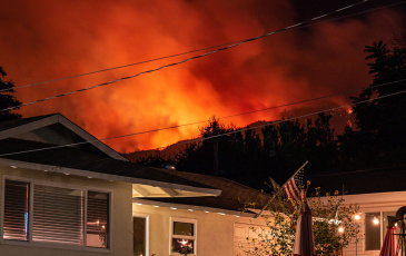 Image of wildfire within distance of residential area/house